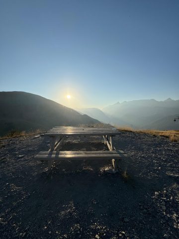 A picnic table at the summit of Les Sures, facing La Meije and the Col du Lautaret