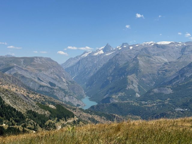 A view of Lake Chambon, La Meije, and the Lautaret Pass from the summit of Les Sûres